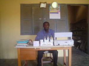 Mr. Kwaku Ananse behind his desk